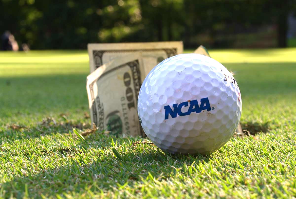 NCAA Golf Ball on putting green with cash